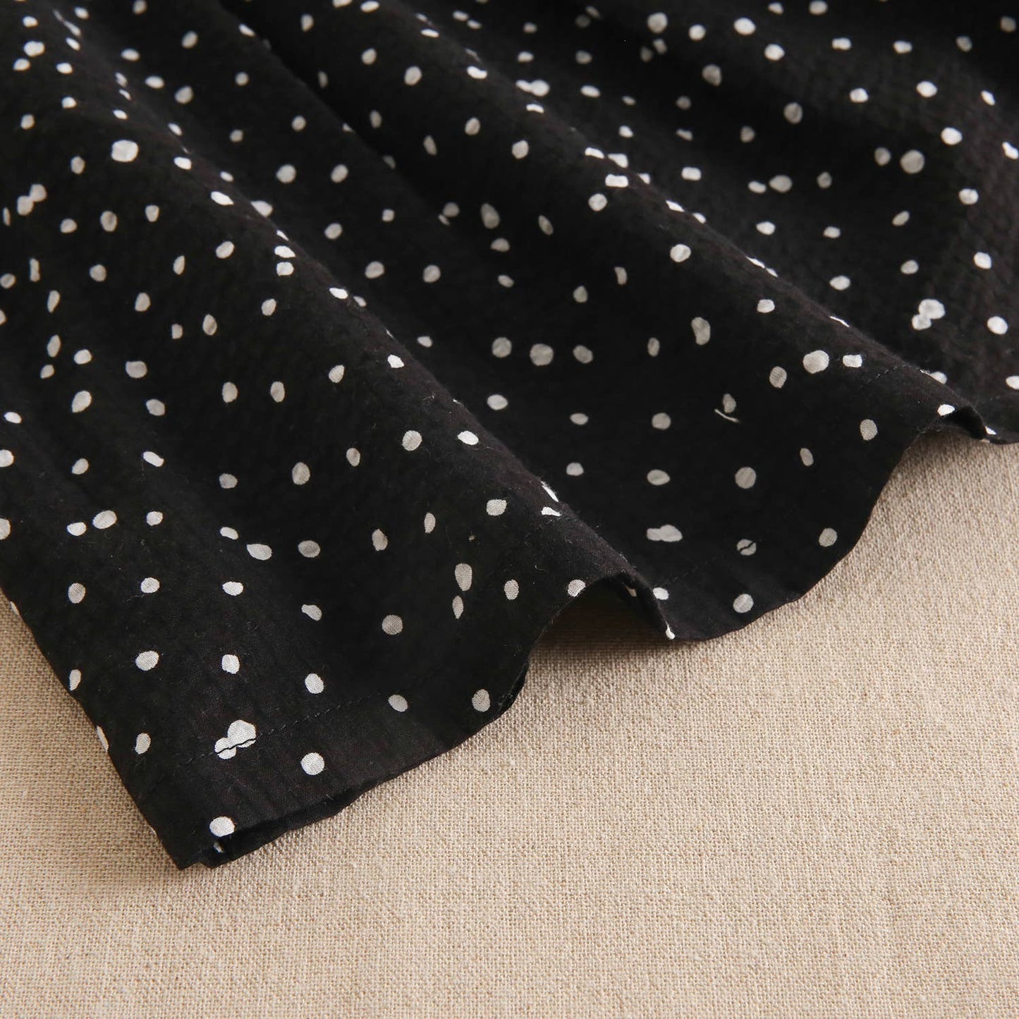 Black girl's dress with white polka dots