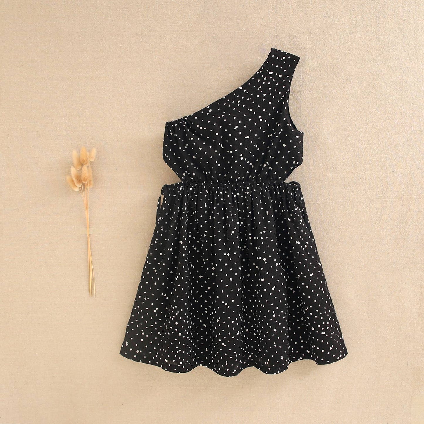 Black girl's dress with white polka dots