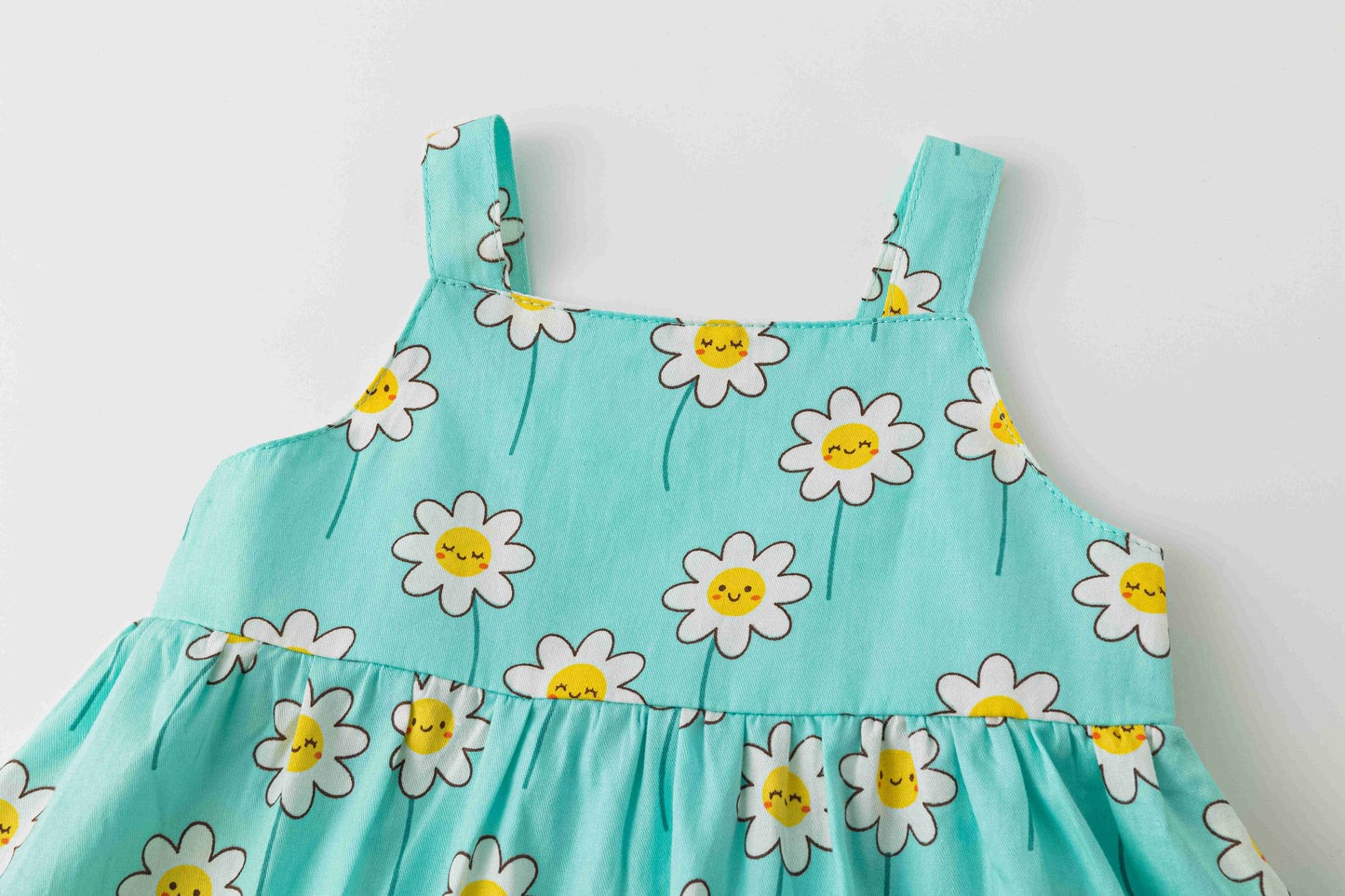 Strappy baby dress with smiling daises