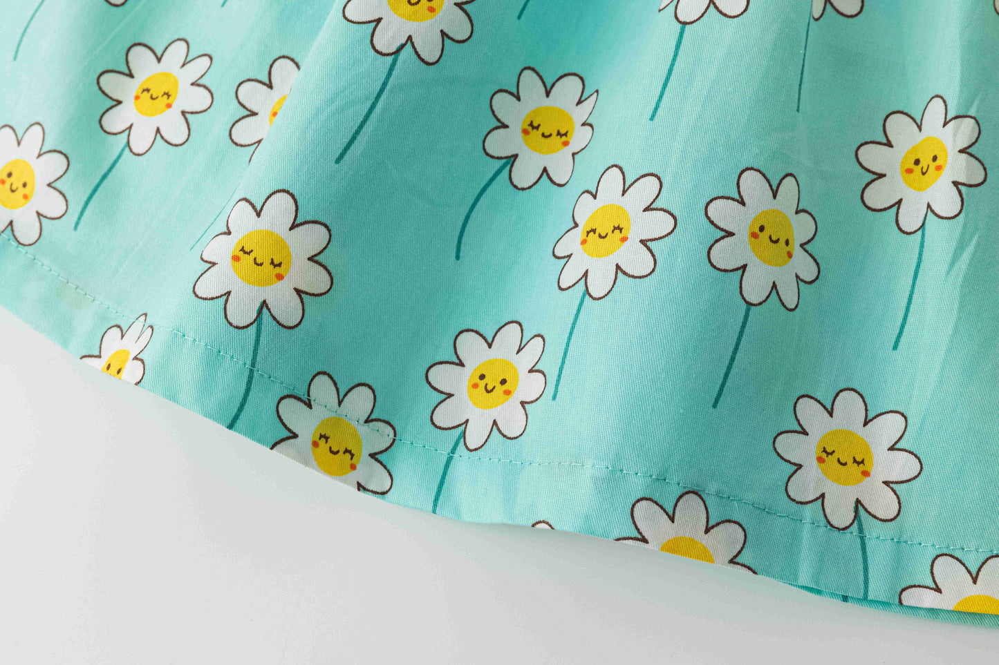 Strappy baby dress with smiling daises