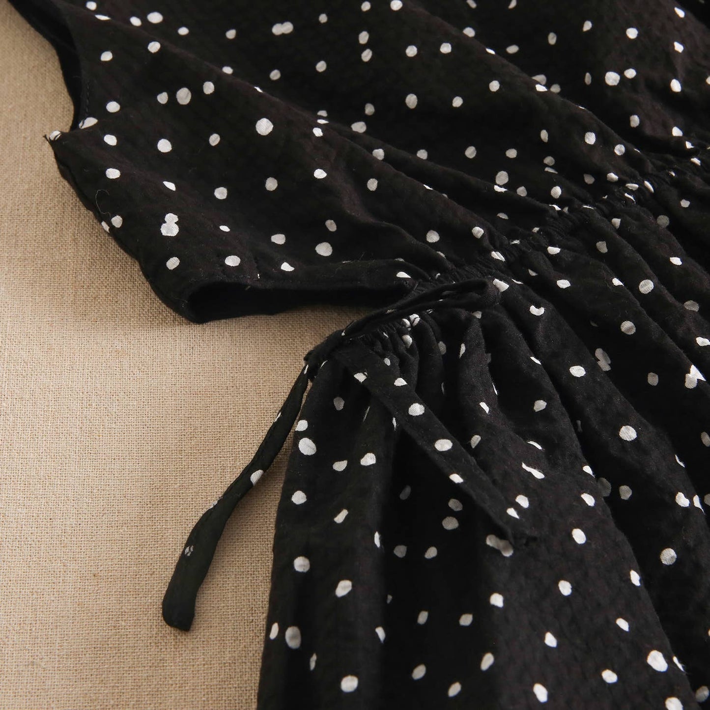 Black girl's dress with white polka dots