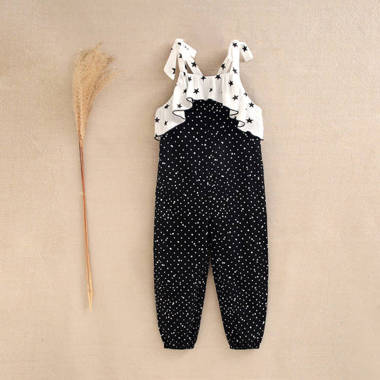 Girls' black jumpsuit with white polka dots