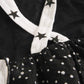 Girls' black jumpsuit with white polka dots