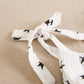 Girls' black jumpsuit with white polka dots